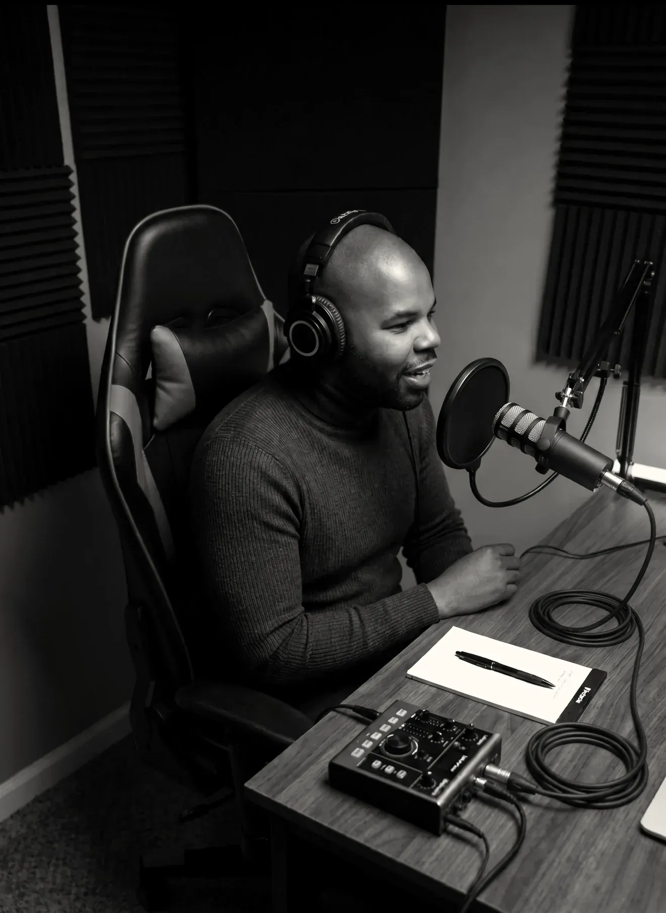 Matthew Scott recording at a microphone in a studio